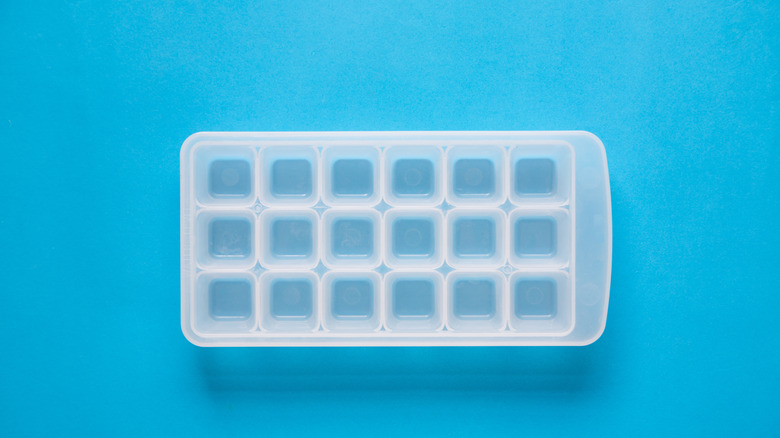 empty ice cube tray on blue background