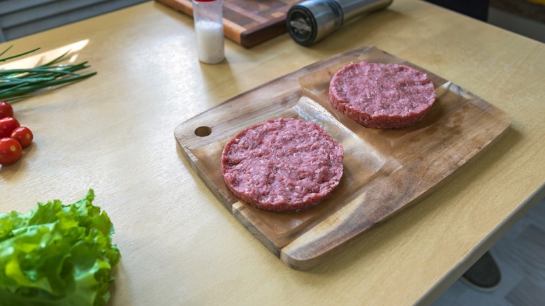 Raw ground beef shaped for burgers