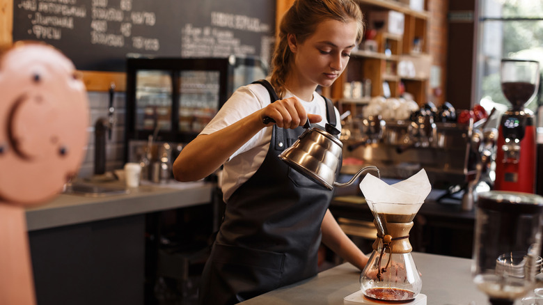 Barista preparing pour-over coffee