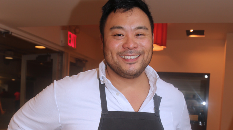 David Chang wearing an apron