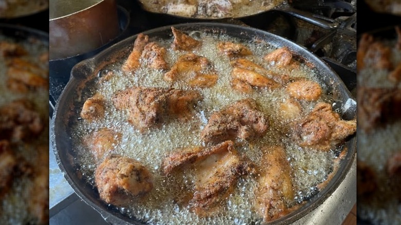 chicken frying in a cast iron skillet