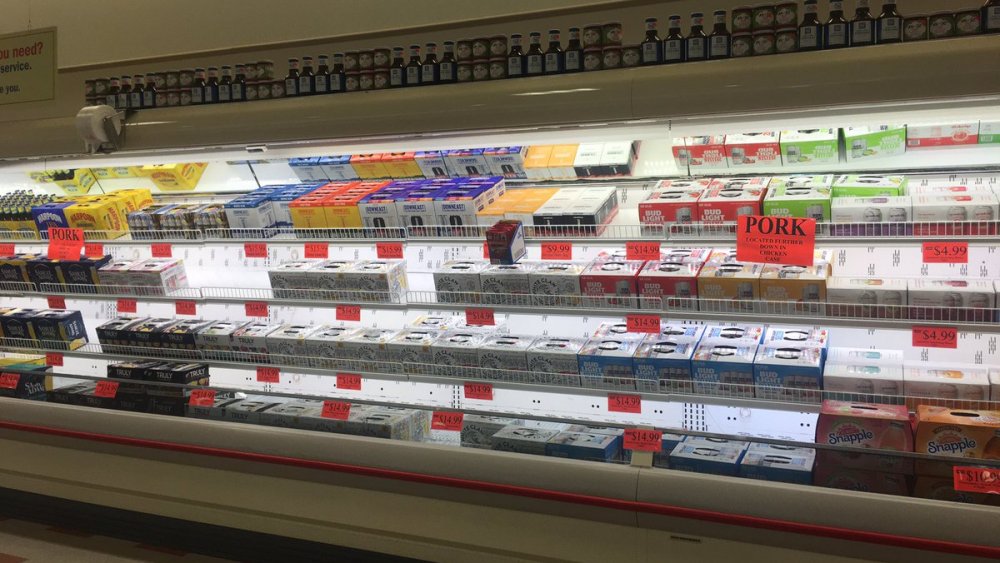 meat case full of beer at grocery store