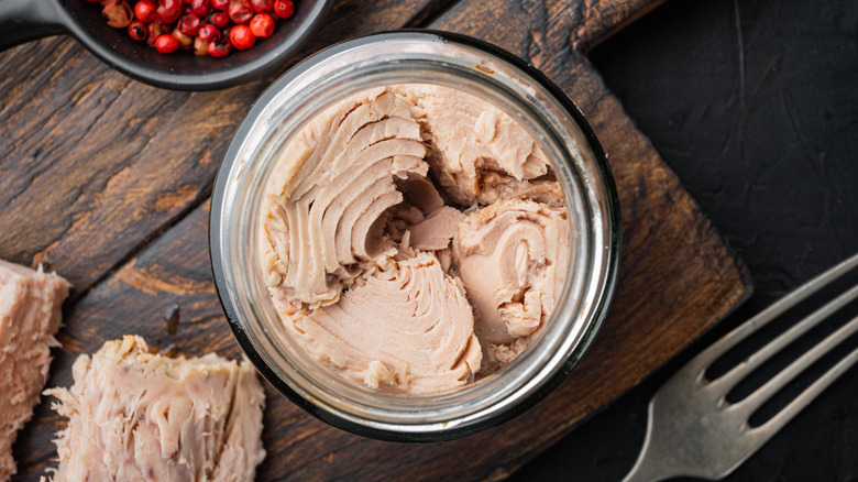 Canned tuna on wooden board