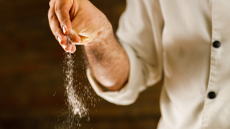 chef adding salt 