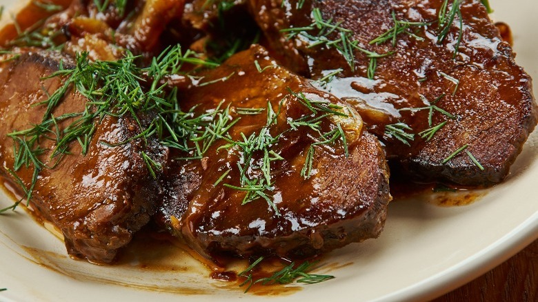 Balsamic braised beef topped with herbs