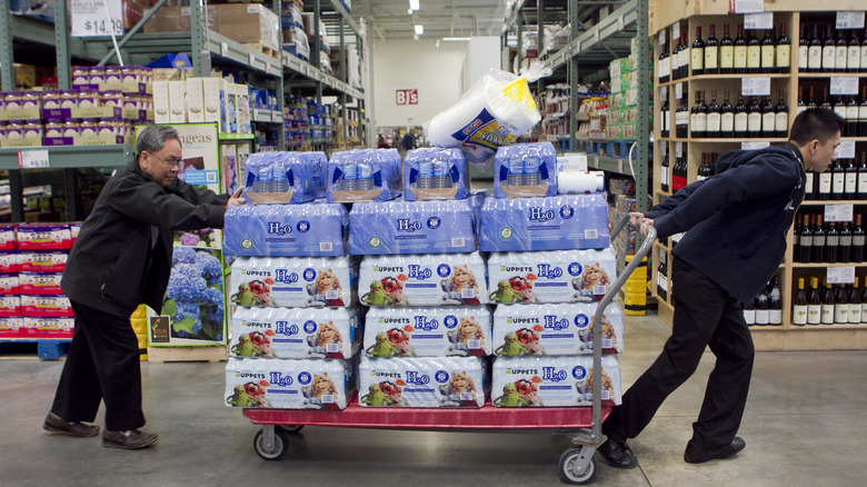 BJ's shoppers with a cart of bottled water