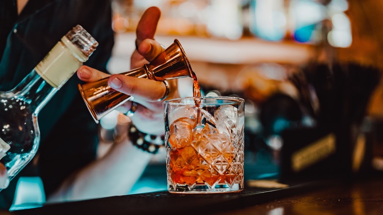 closeup of person making cocktail