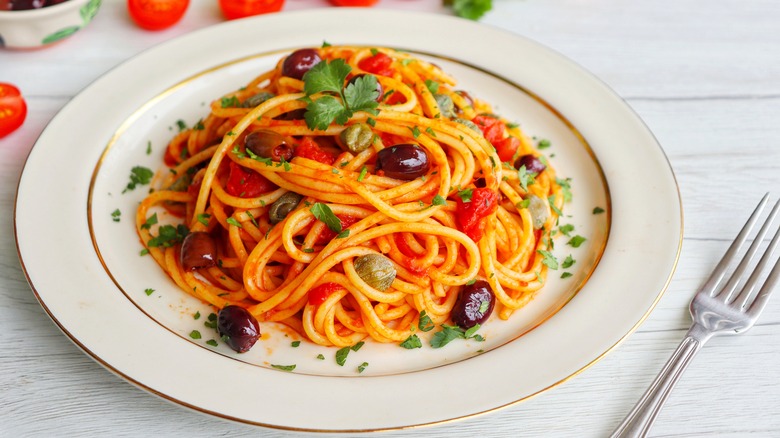 pasta puttanesca on white plate