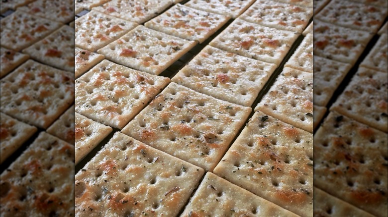 line of crackers with butter and seasoning