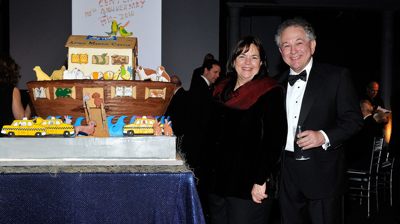 Ina and Jeffrey Garten standing next to a cake at a benefit