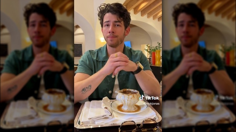 Nick Jonas eating a bowl of French Onion Soup