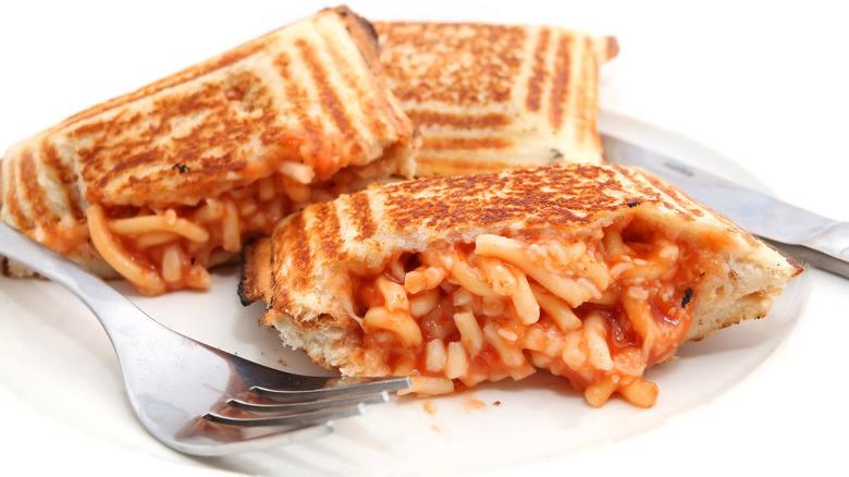 A toasted sandwich with spaghetti inside