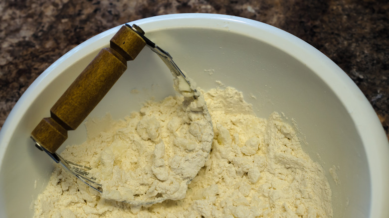 Pasty blender cutting butter into dough