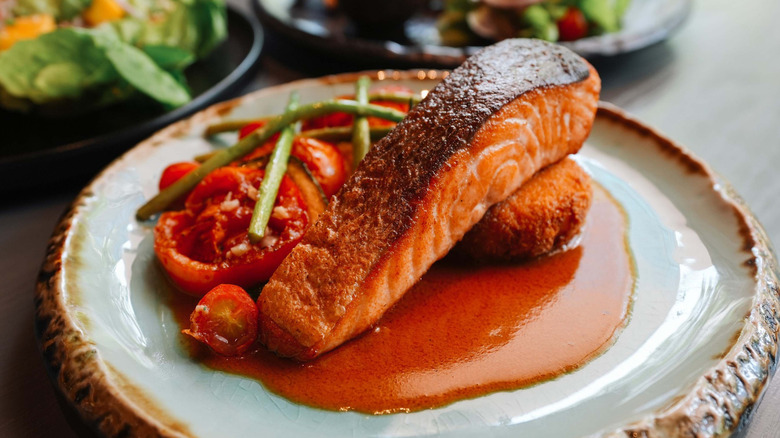 Crispy and juicy salmon served with vegetables and sauce