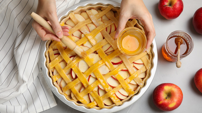 Egg washing on apple pie 