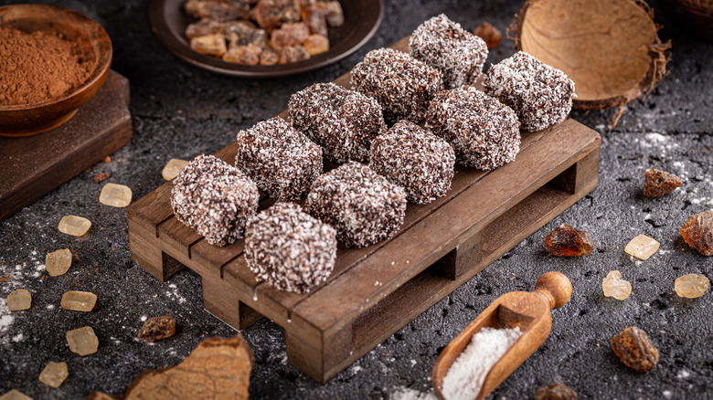 ten lamington cakes on wooden slab