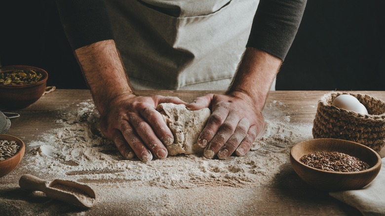 Person working with flour and dough