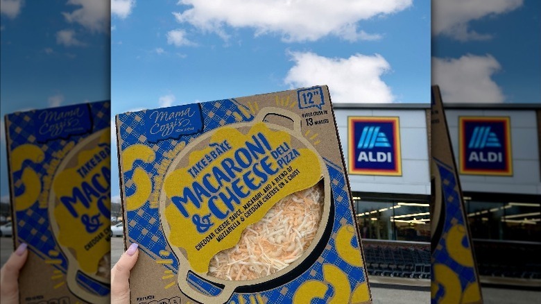 Person holding box of Aldi macaroni and cheese pizza