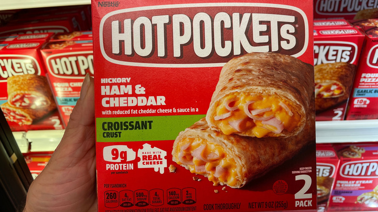 hand holding Hot Pockets box