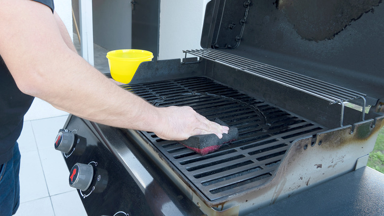 Man cleaning his grill