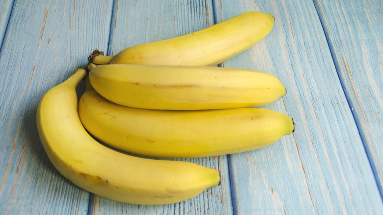 Shopper placing bananas in basket