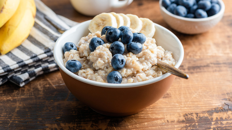 Bowl of oatmeal with blueberries and sliced bananas