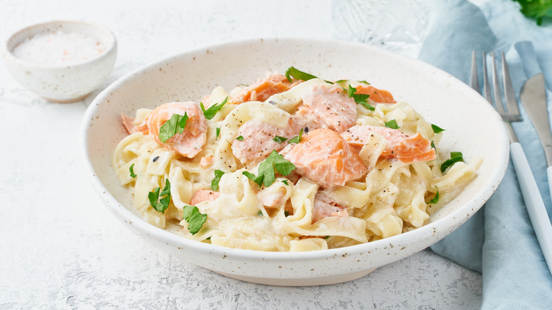 salmon pasta in white bowl