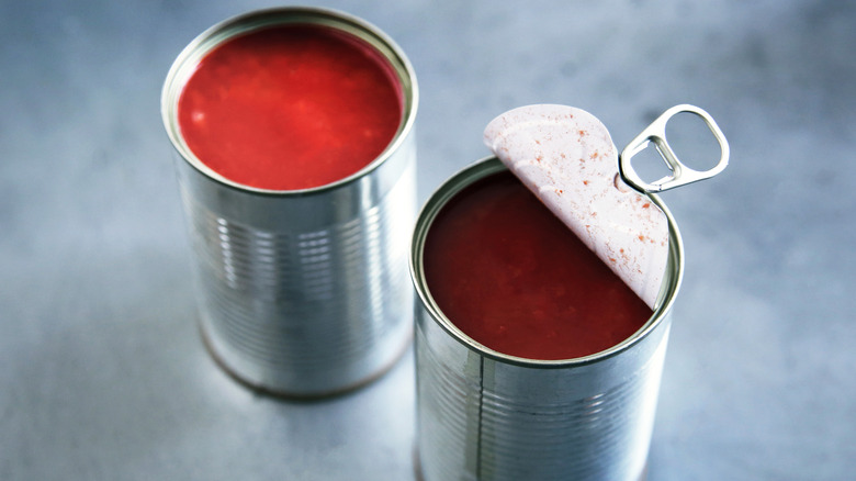 Tomato paste in aluminum cans with lid open