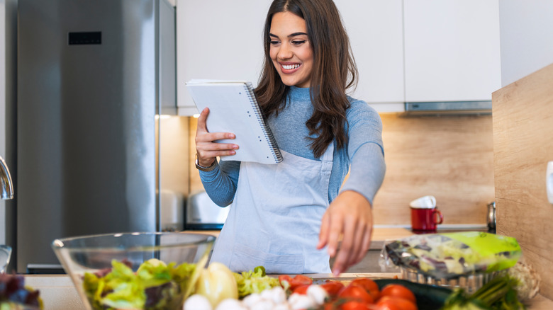 Woman reading recipe in kitchen