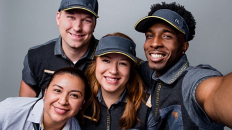 four McDonald's employees smiling