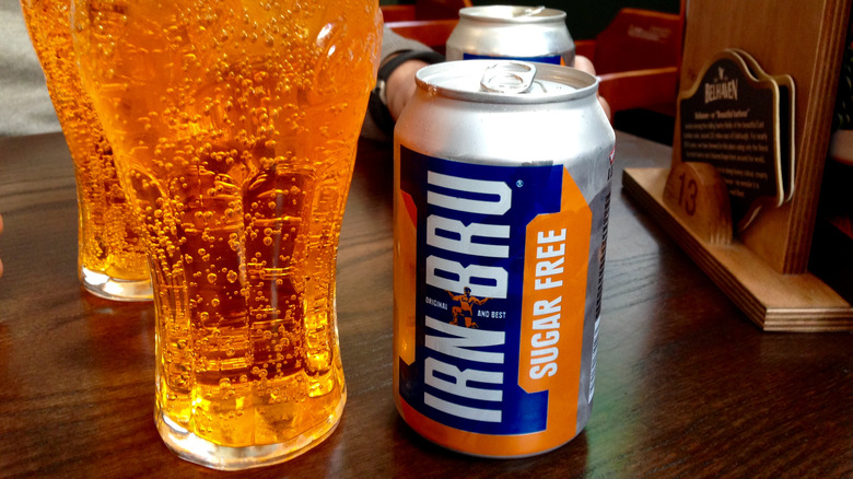 Two glasses and cans of Irn-Bru