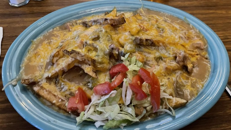 Open-faced burger with green chili and cheese