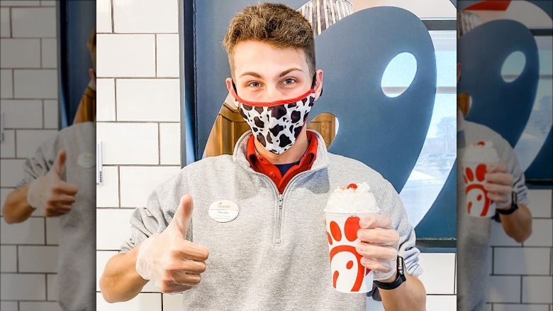 Chick-fil-A employee holding milkshake