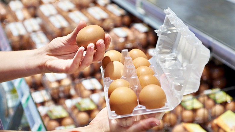 Selecting eggs at store