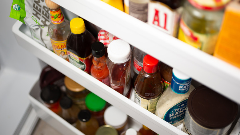 crowded condiment shelf in refrigerator