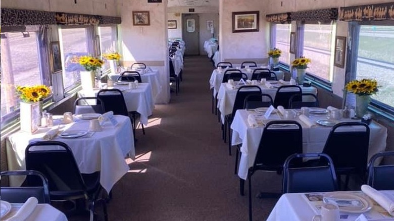 Charlie Russell Chew Choo Dinner Train interior shot of the tables all set in a dining car