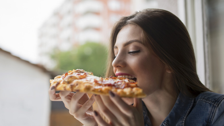 eating pepperoni pizza