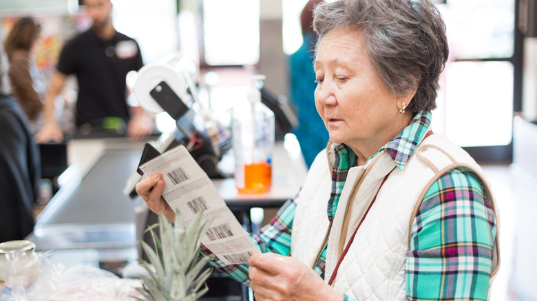 woman with coupons in grocery store