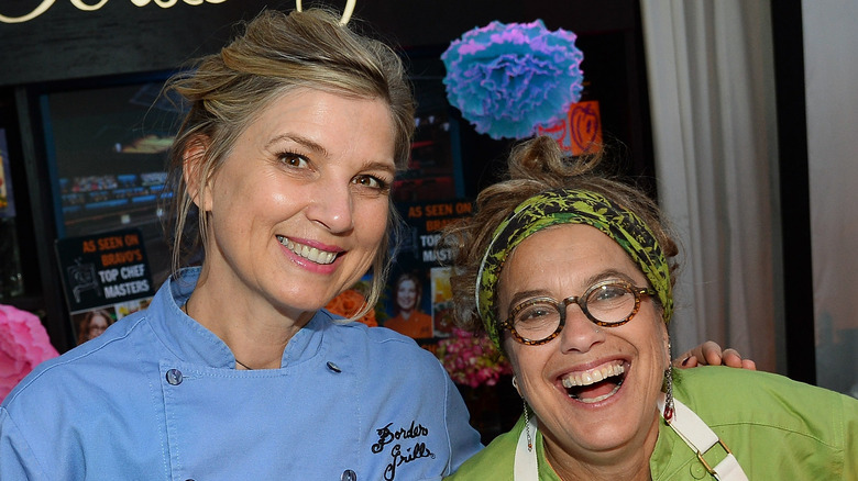 Chefs Mary Sue Milliken (L) and Susan Feniger pose at their Border Grill restaurant booth at Vegas Uncork'd by Bon Appetit's Grand Tasting event at Caesars Palace on May 9, 2014 in Las Vegas, Nevada.