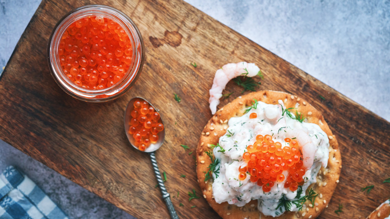 Orange caviar on seafood and in a jar 