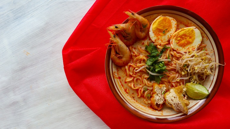 Laksa against a red background