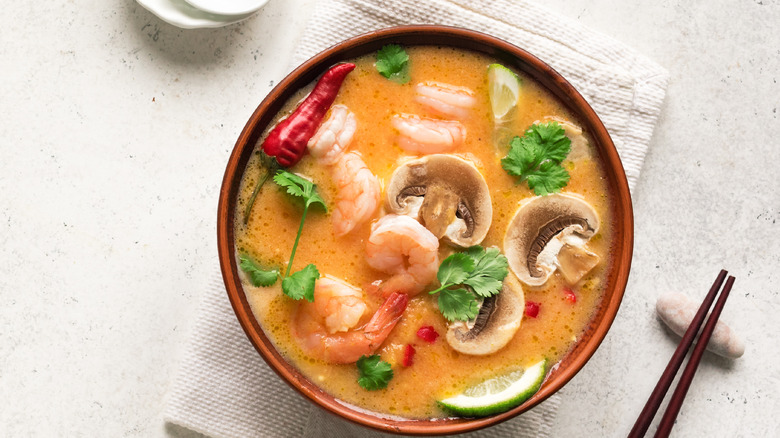 Tom yum soup against a white background