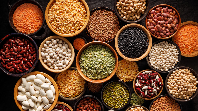 bowls of varying sizes holding different legumes and pulses