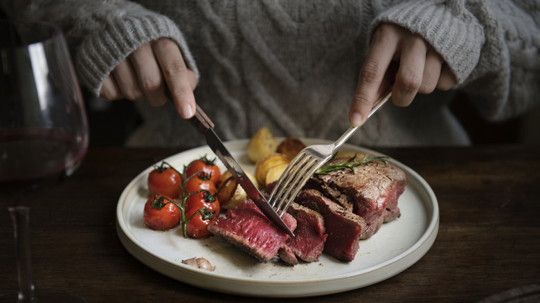 Person eating a steak