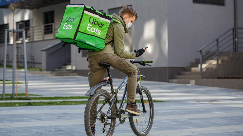 Uber eats delivery person with a green bag