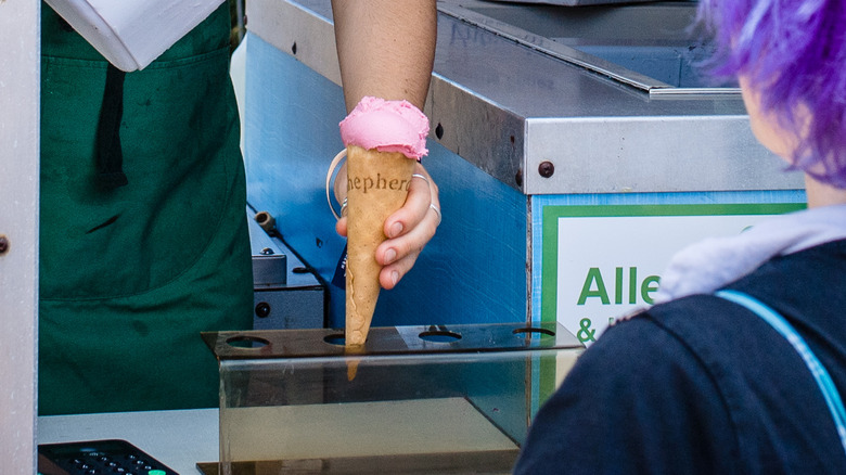 Woman serves ice cream cone