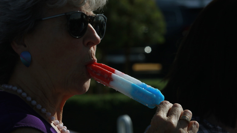 Woman eats popsicle