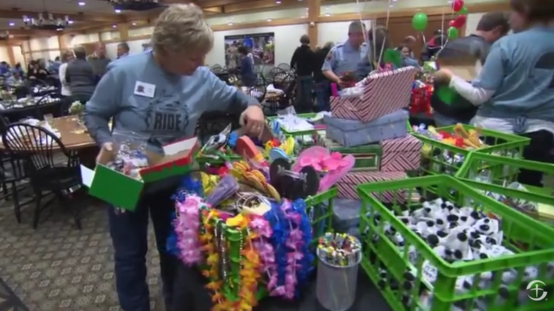 People packing boxes for kids at charity event