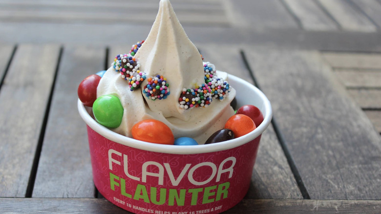 Cup of frozen yogurt with candy