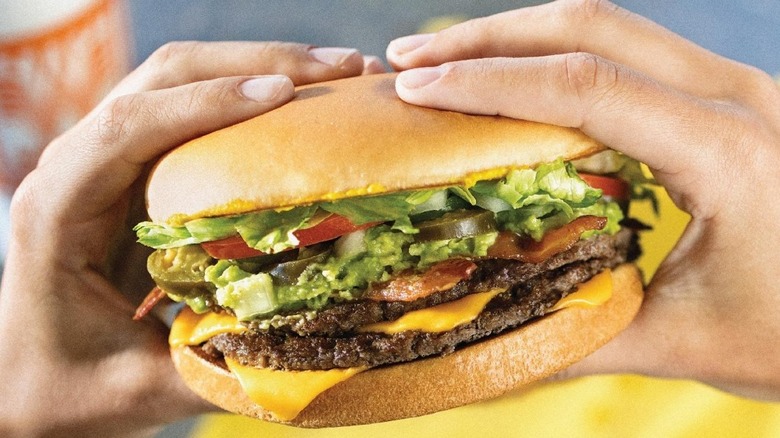 Person holding a Whataburger